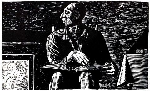 Man seated with an open book in his lap, looking to the side